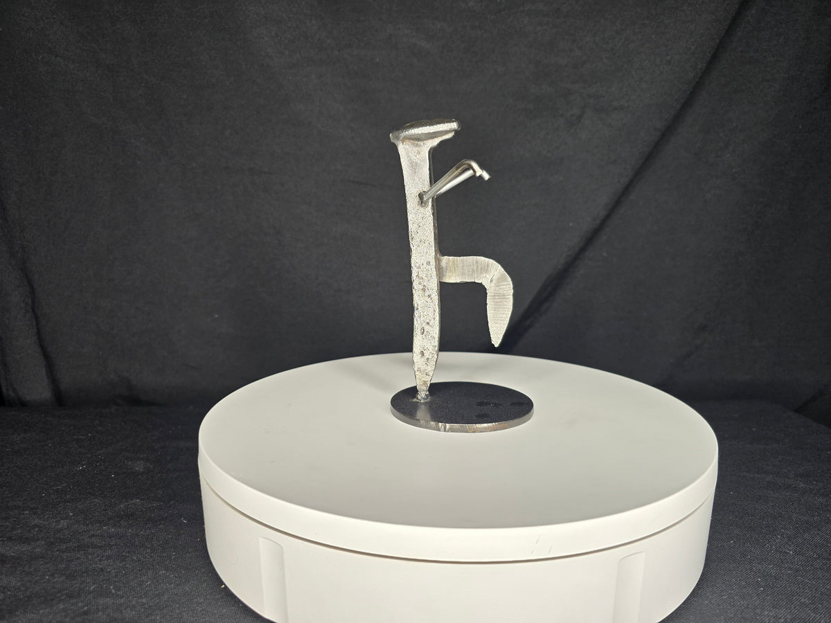 The Martial Artist reclaimed railroad spike sculpture balanced in the iconic Crane Technique martial arts stance.