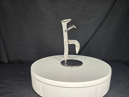 The Martial Artist reclaimed railroad spike sculpture balanced in the iconic Crane Technique martial arts stance.