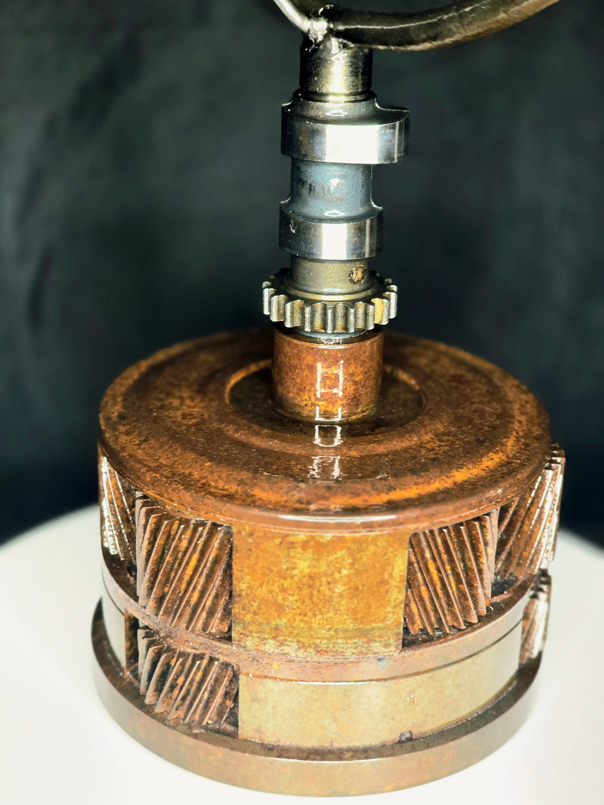 Ikarus: The Day After sculpture detail: rusted gear and metal shaft.