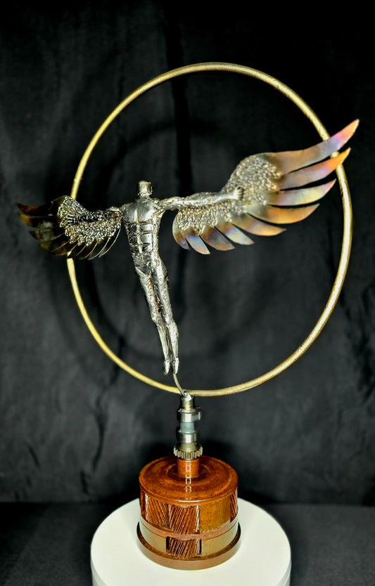Decorative winged figurine ornament on gold ring stand with wooden base