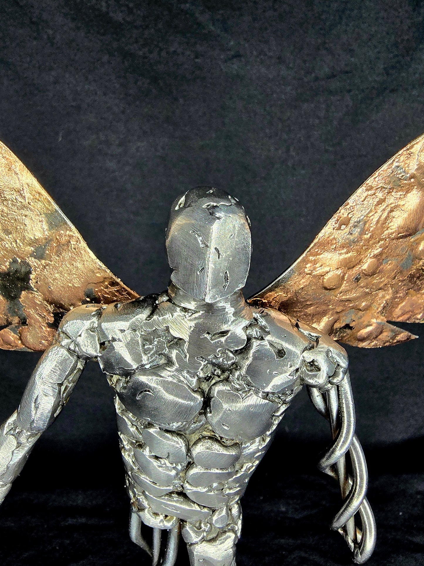 Metal angel ornament head and upper body with gold wings behind