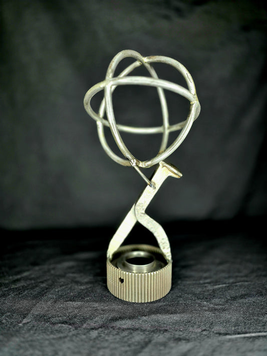 Atlas Revisited sculpture by Enrique Del Angel, featuring a wire globe atop a bent metal figure.