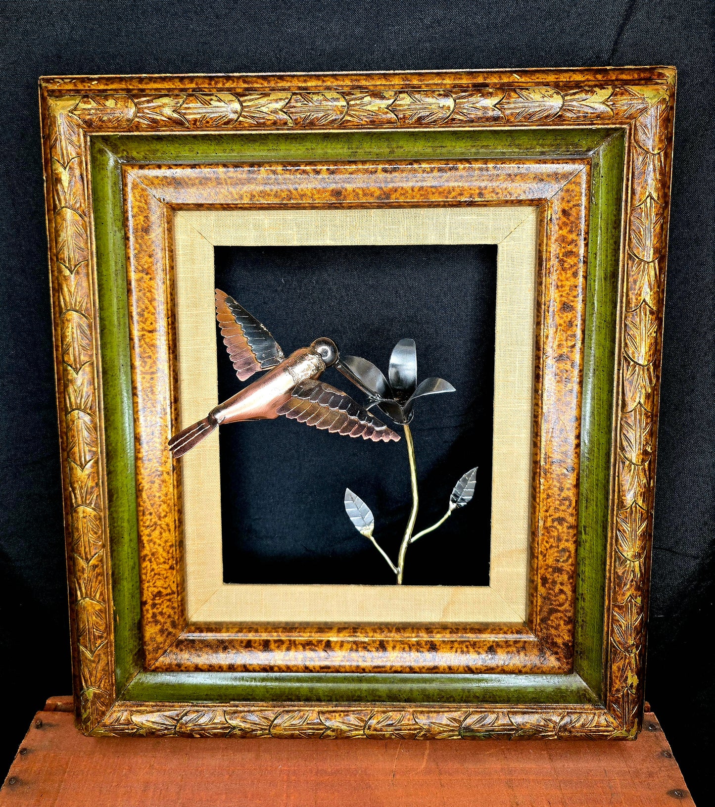 Handcrafted metal hummingbird and flower wall sculpture made from reclaimed steel, designed to capture movement and nature by Enrique Del Angel.