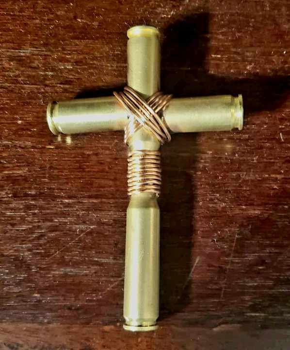 Handcrafted brass shell cross sculpture by Enrique Del Angel, reclaimed brass metal art