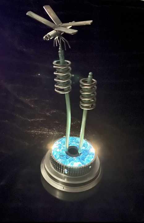 Blue LED metal spring device with two rods on a circular base