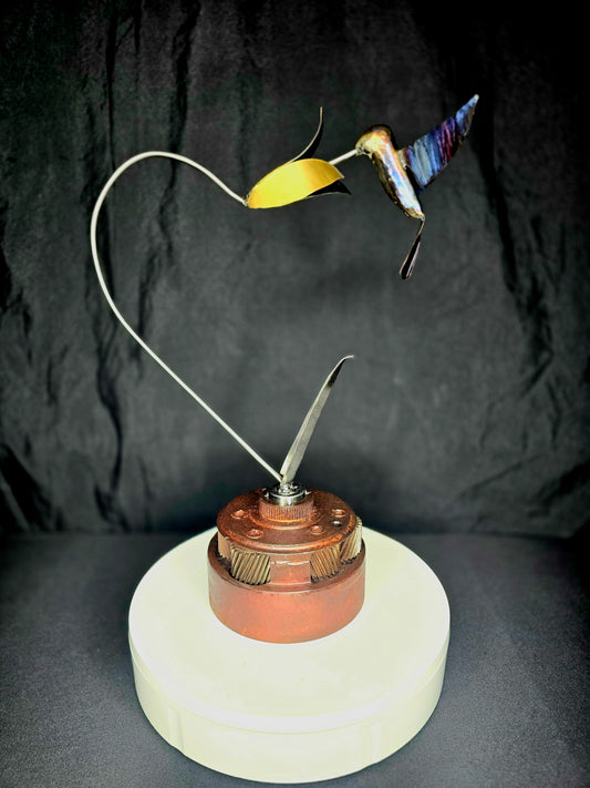 Hummingbird metal ornament with yellow tail and multi-color wings on copper base, full view