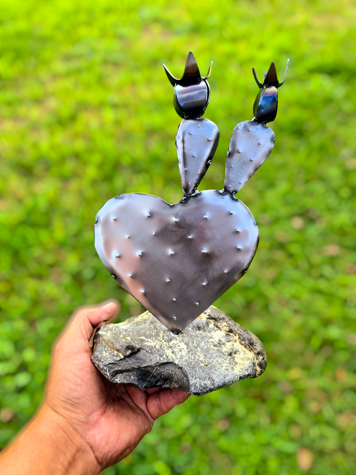 Espinas y Abrazos welded steel cactus heart family sculpture on a natural stone base by Enrique Del Angel handcrafted from upcycled sheet metal