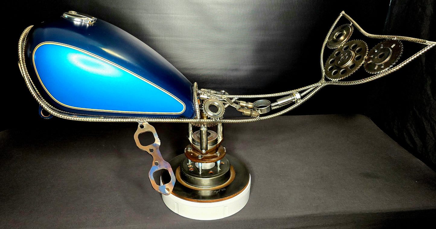 4D sculpture, rotating, whale metal sculpture made from motorcycle fuel tank, gears, and automotive rotor by Enrique Del Angel.