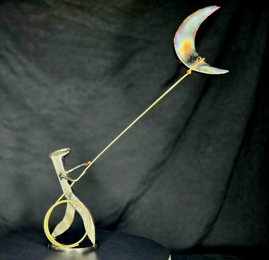 I Swear: By the Stars and the Moon Above mixed-media metal sculpture by Texas artist Enrique Del Angel, featuring a railroad spike cowboy roping a crescent moon filled with stars.