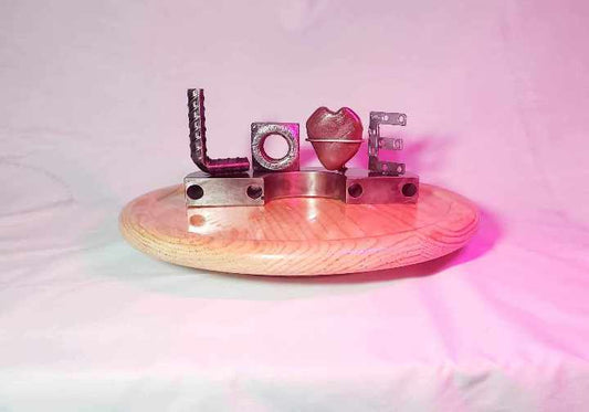 Handcrafted metal "Love" word sculpture by Enrique Del Angel, reclaimed steel art