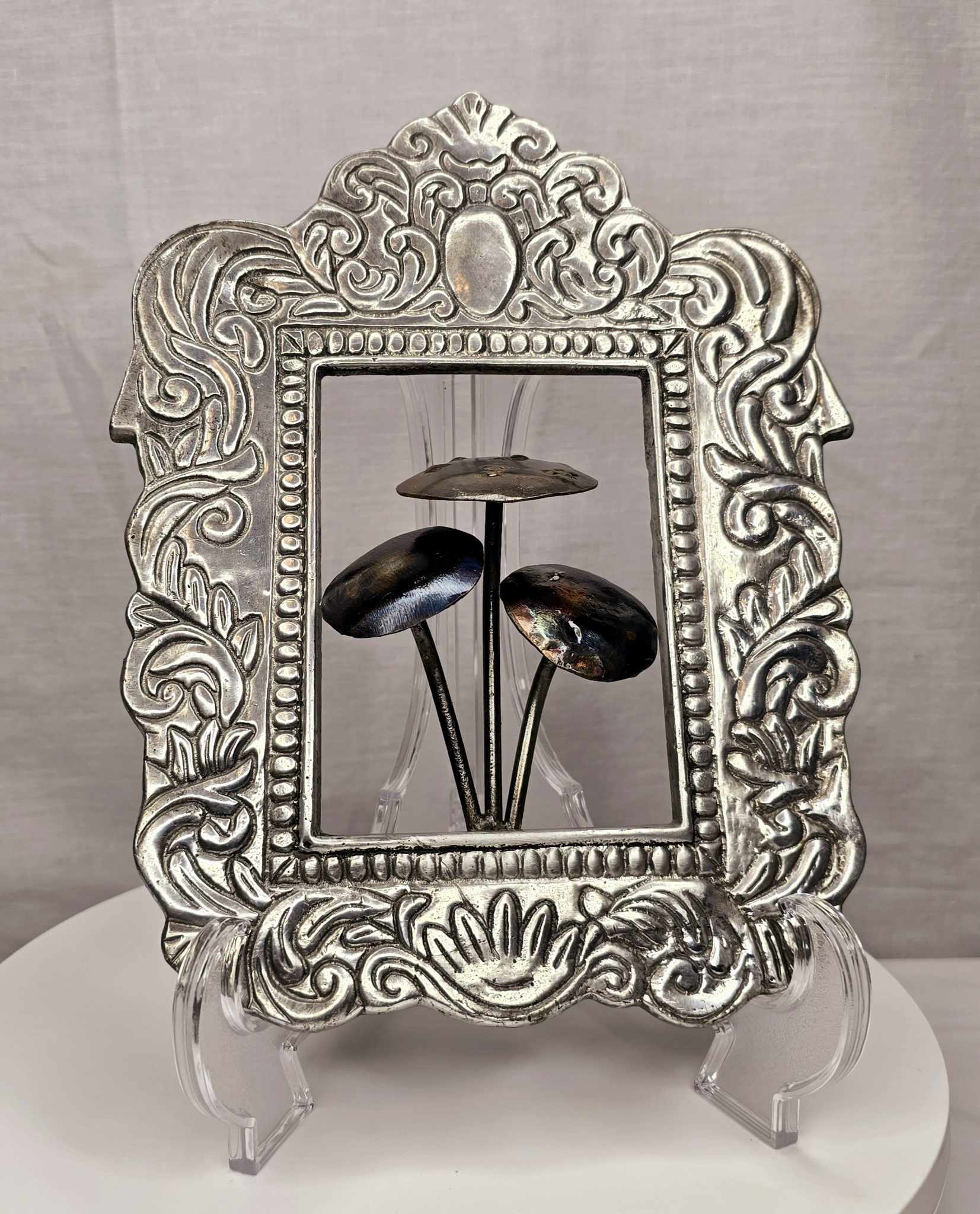 Mushroom of the Forge: Three handcrafted metallic mushrooms inside an ornate silver-tone frame.