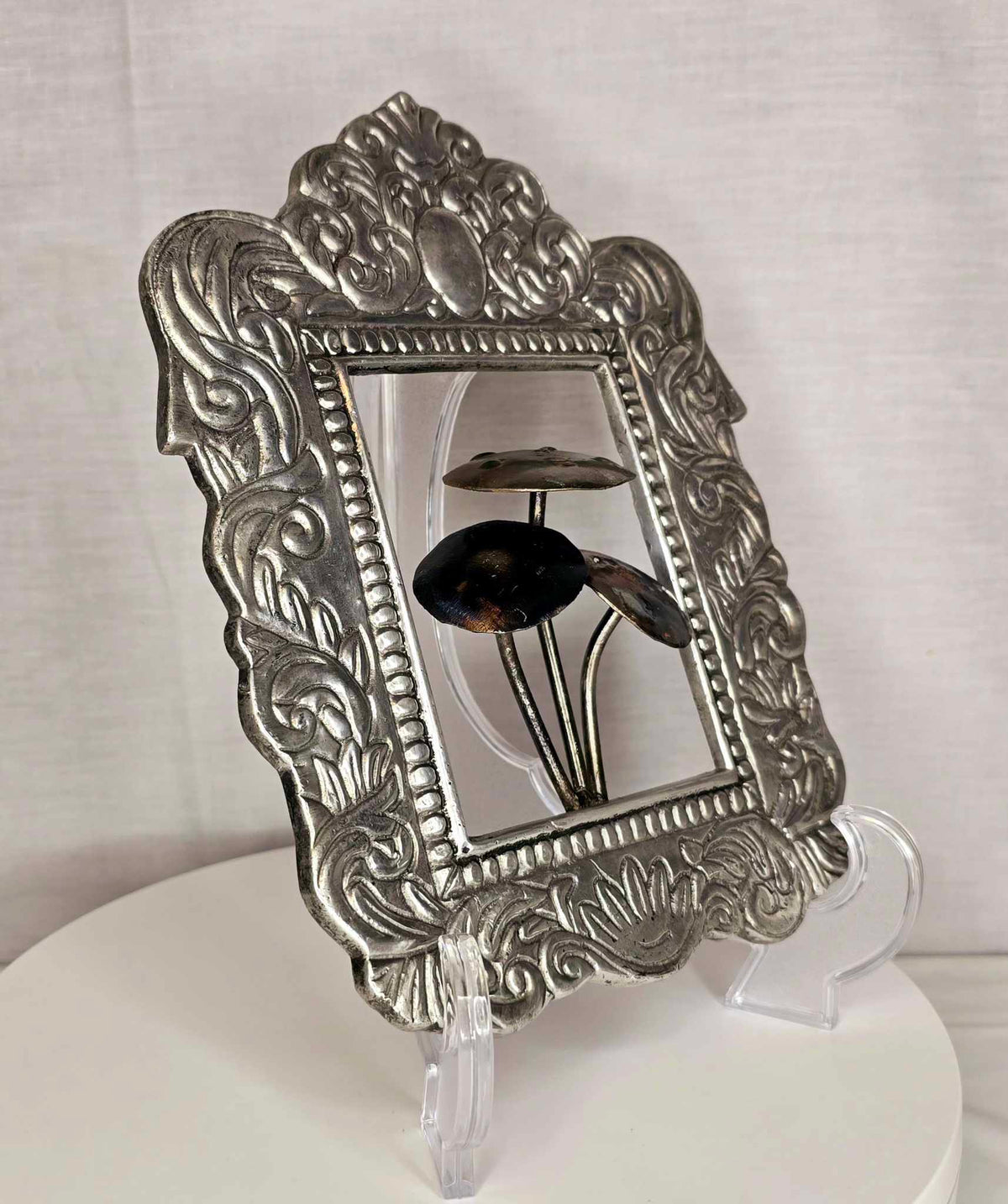 Mushroom of the Forge: Ornate silver-tone frame with three metallic mushrooms.