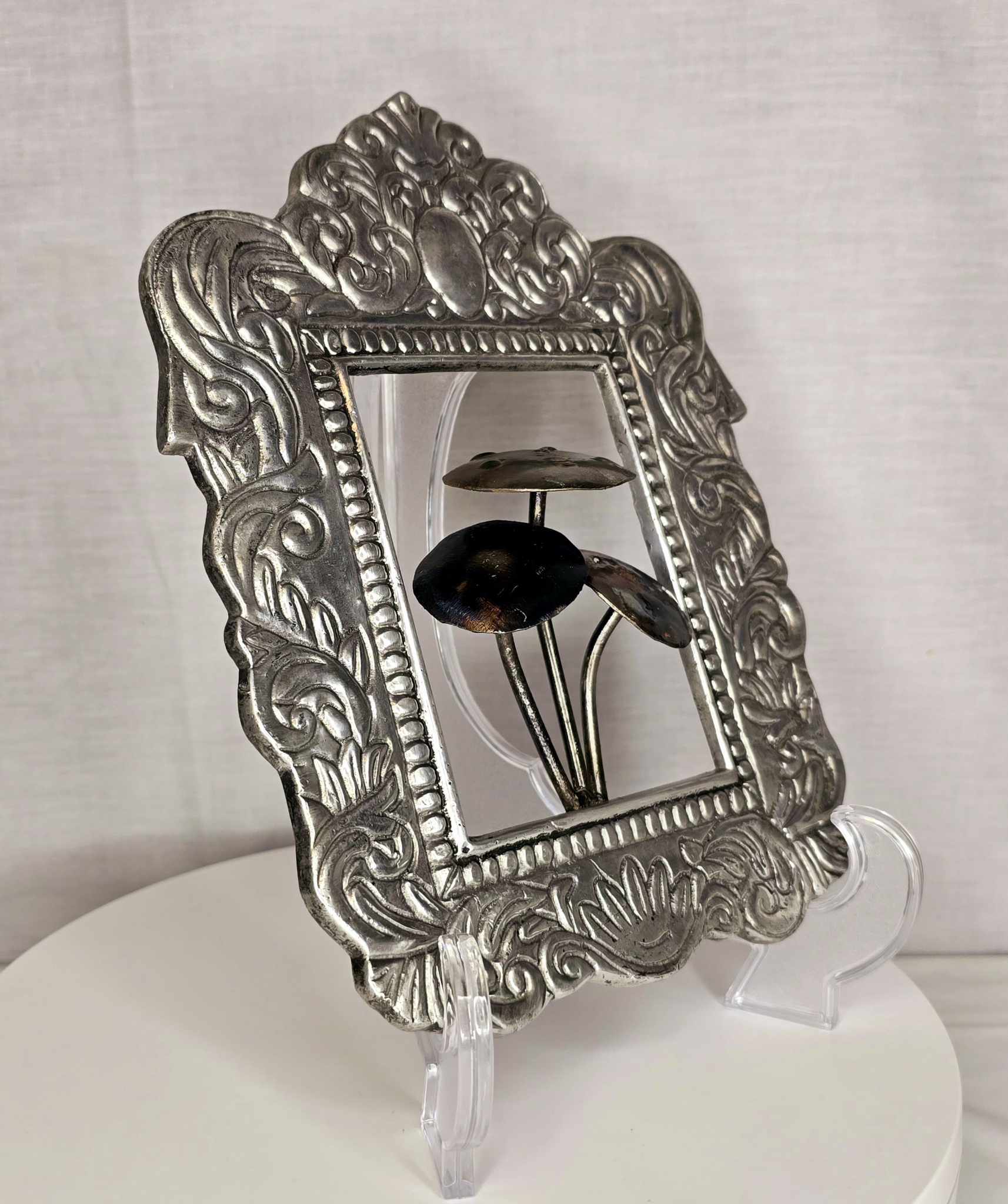 Mushroom of the Forge: Ornate silver-tone frame with three metallic mushrooms.