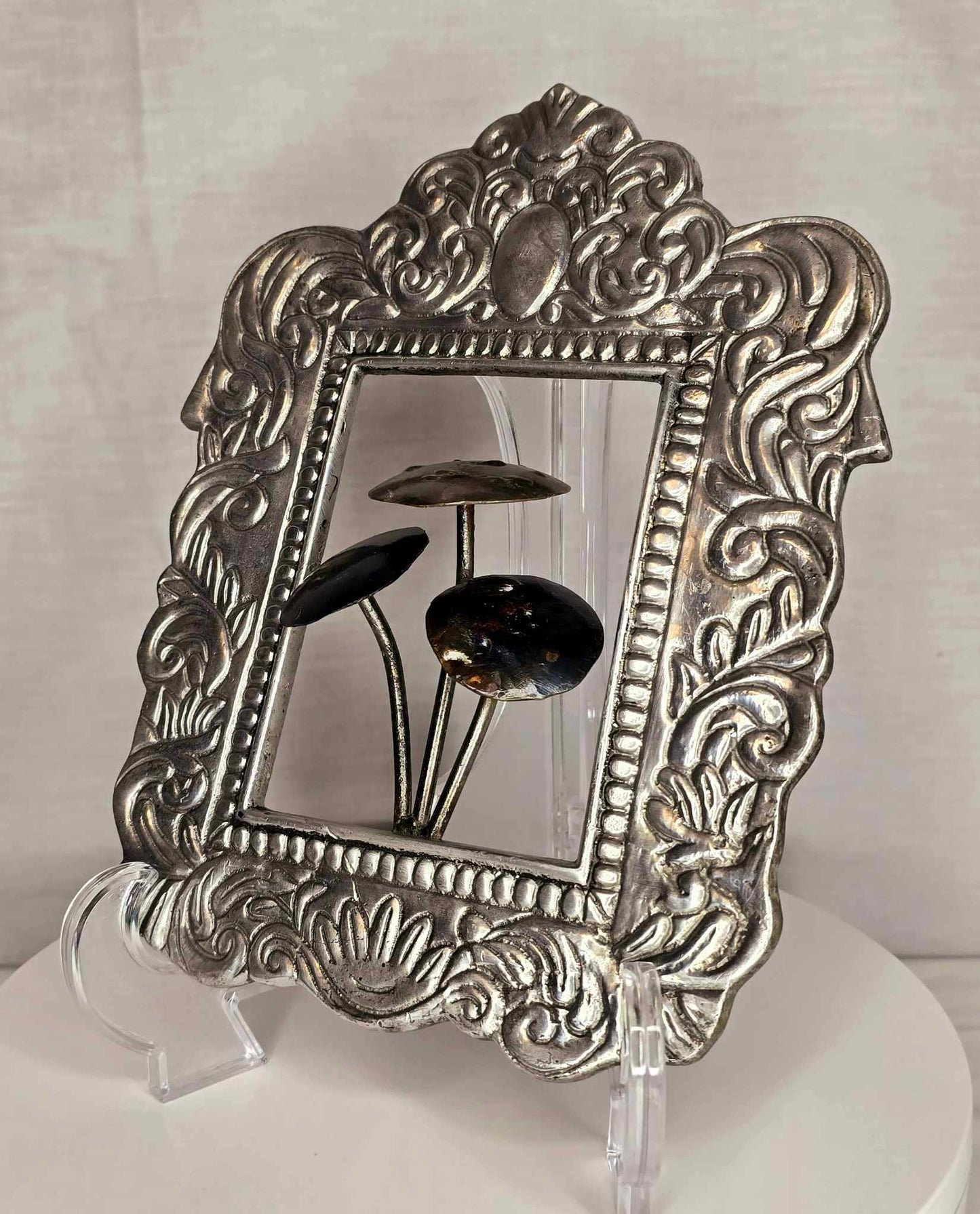 Mushroom of the Forge: Ornate silver-tone frame with three metallic mushrooms.