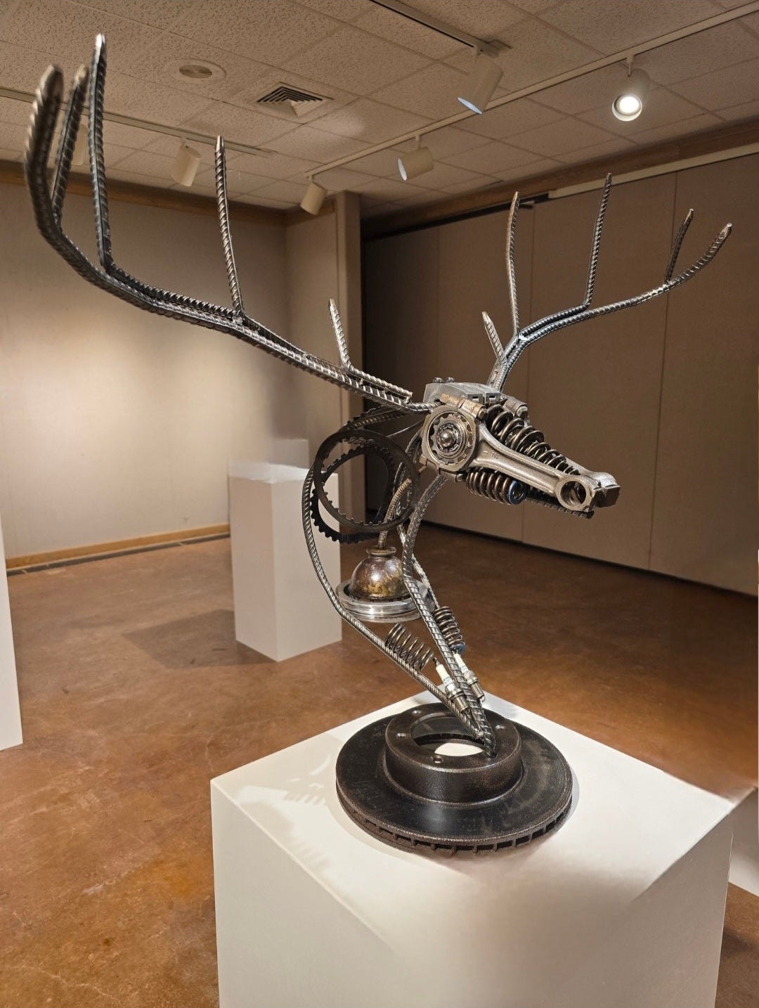 Handcrafted metal deer sculpture "No Bucks Given" by Enrique Del Angel, reclaimed steel art