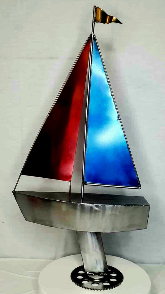 Sailboat metal sculpture symbolizing endurance and the passage of time, forged from reclaimed steel by Enrique Del Angel.