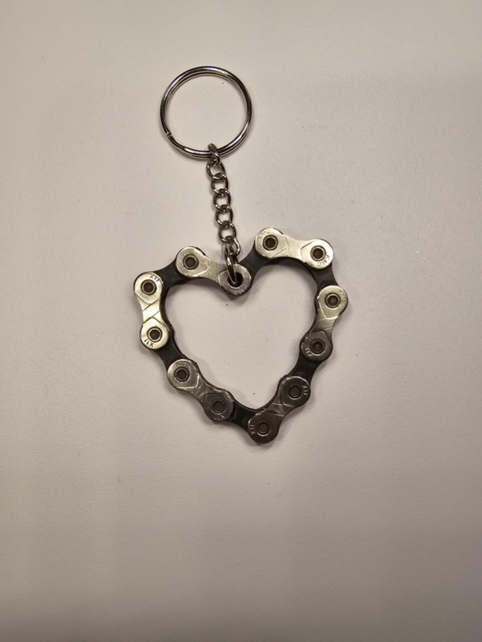 Pocket Sculptures welded steel heart keychain by Enrique Del Angel handcrafted from an upcycled mechanical bicycle chain