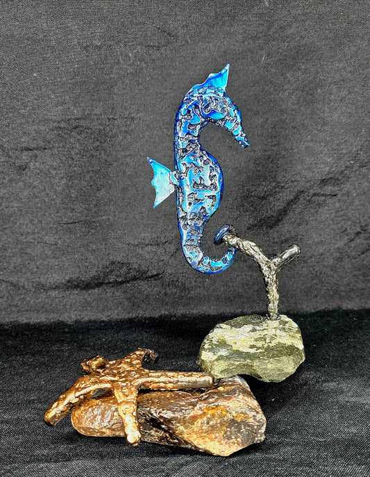 Handcrafted metal seahorse sculpture inspired by ocean resilience, made from reclaimed steel, brass, and automotive parts by Enrique Del Angel.