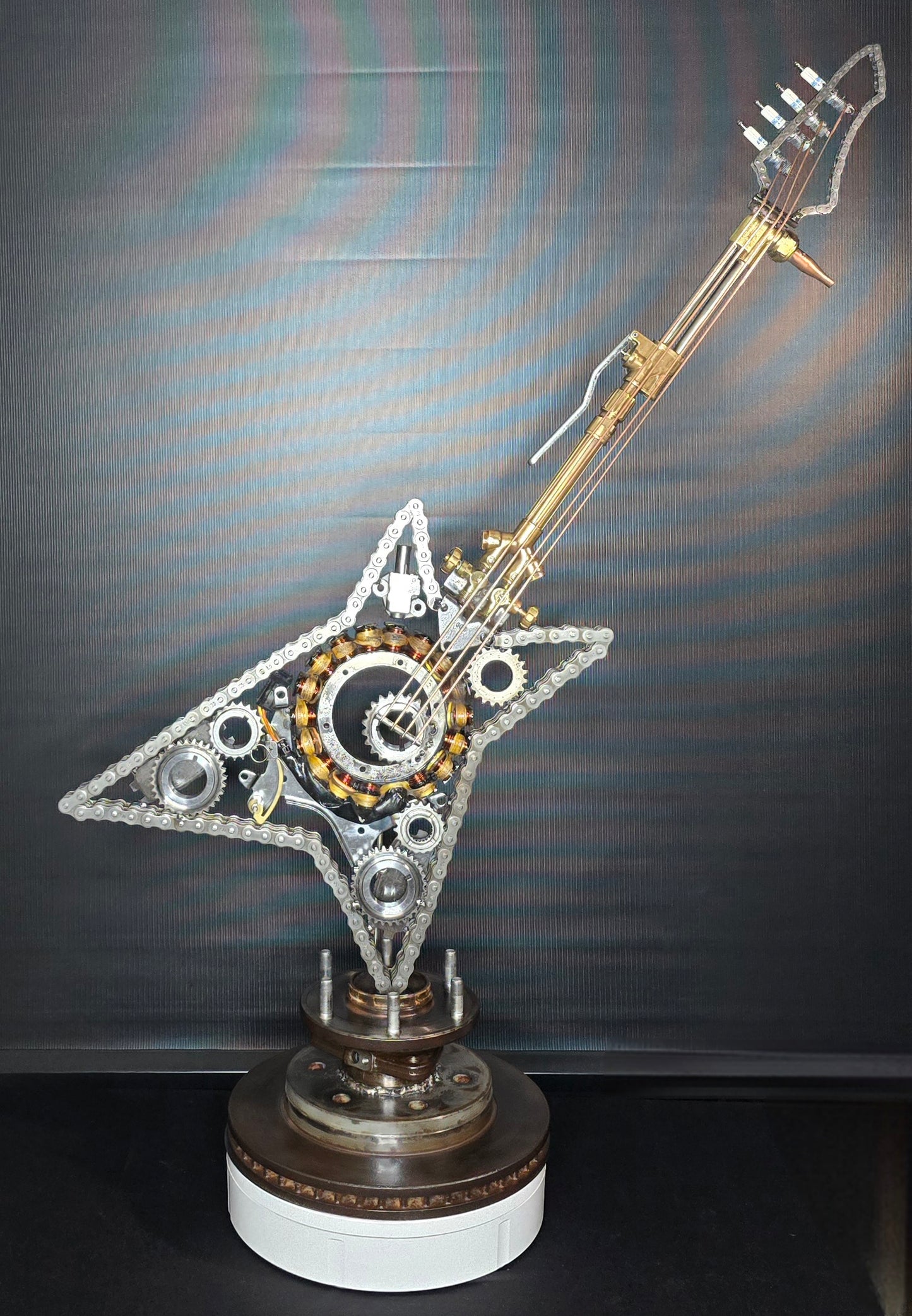 Metal guitar sculpture inspired by fire, transformation, and resilience, forged from reclaimed steel by Enrique Del Angel.