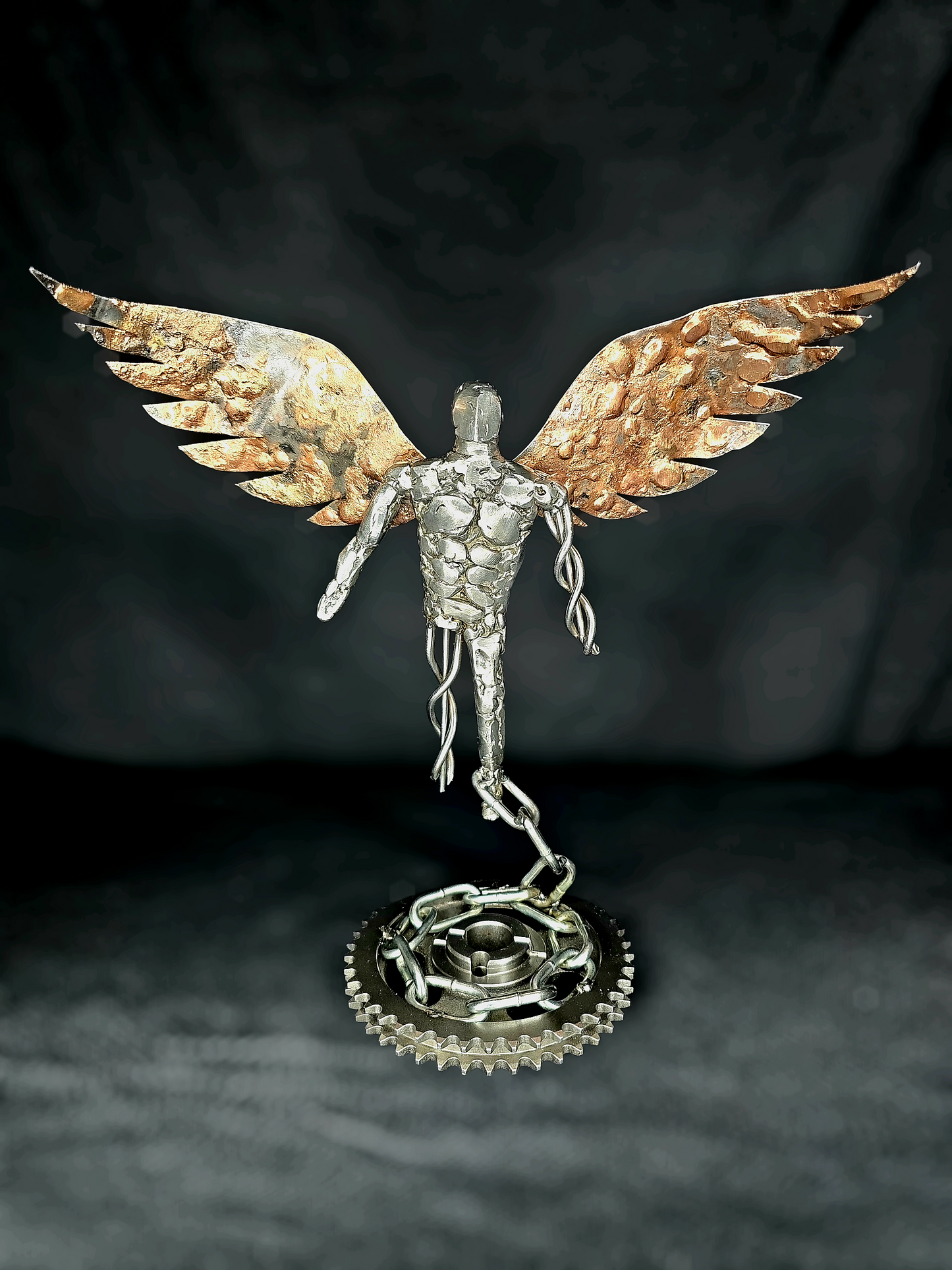 Handcrafted metal angel sculpture symbolizing resilience, grace, and the human spirit, made from reclaimed steel by Enrique Del Angel.