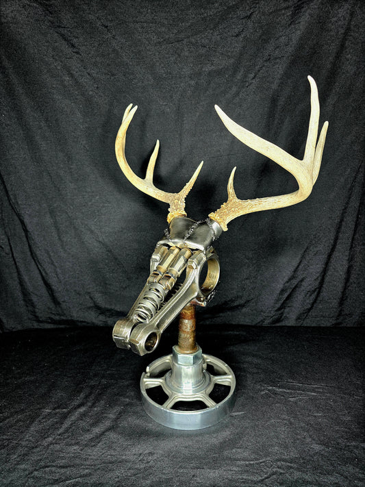 Handcrafted metal deer sculpture with real antlers, made from reclaimed automotive parts by Enrique Del Angel.