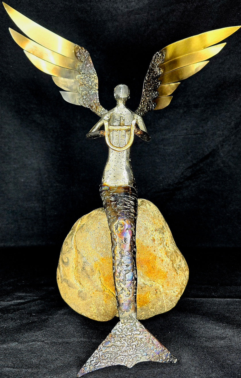 Winged siren metal sculpture inspired by Greek mythology, forged from reclaimed steel by Enrique Del Angel.
